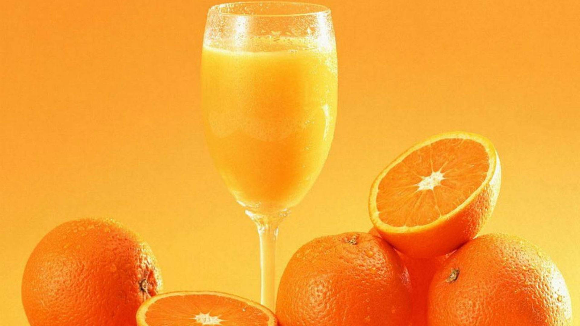 Download Orange Fruit Juice In Glass Wallpaper 