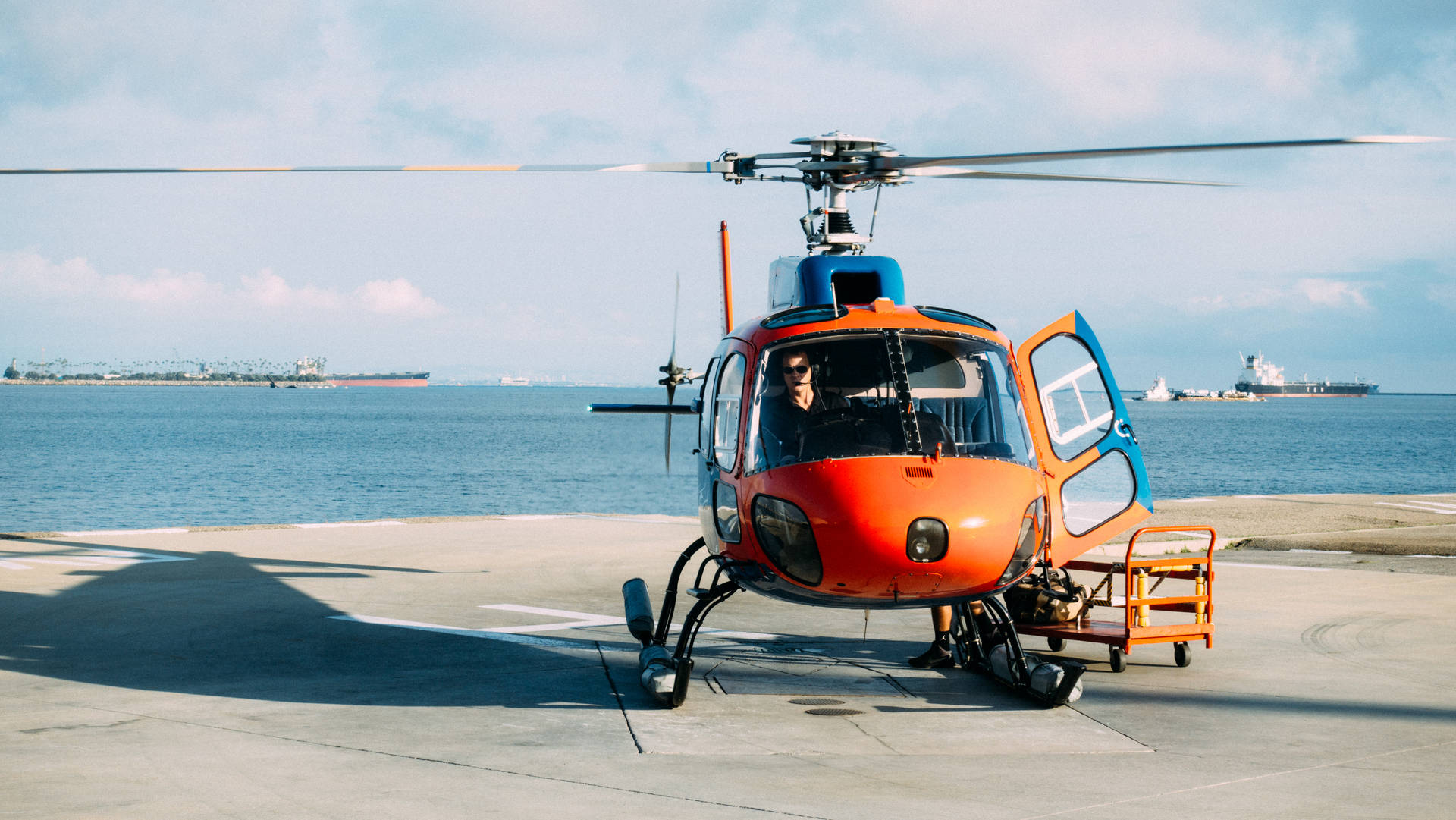 Orange Helicopter Near Sea Wallpaper