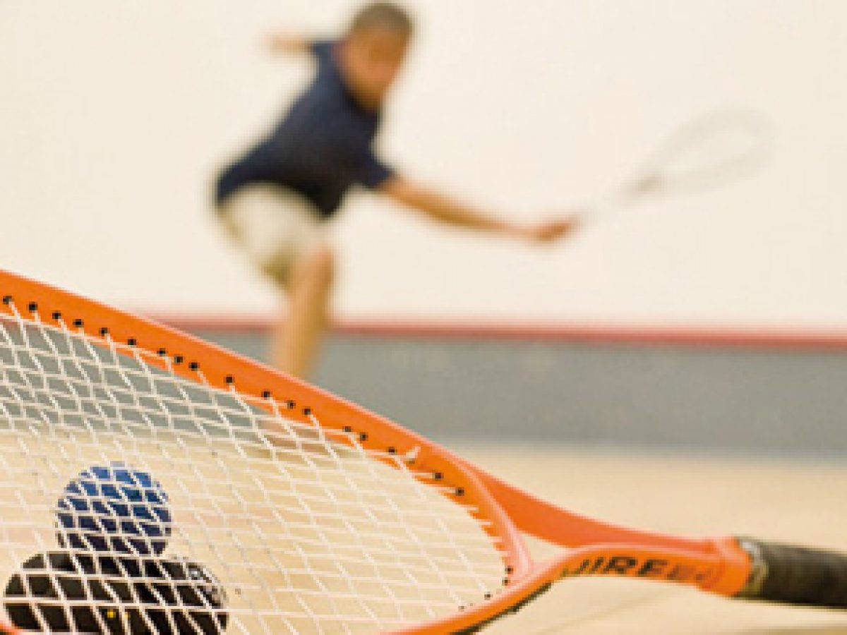 Orange Squash Racket With Hollow Balls Background