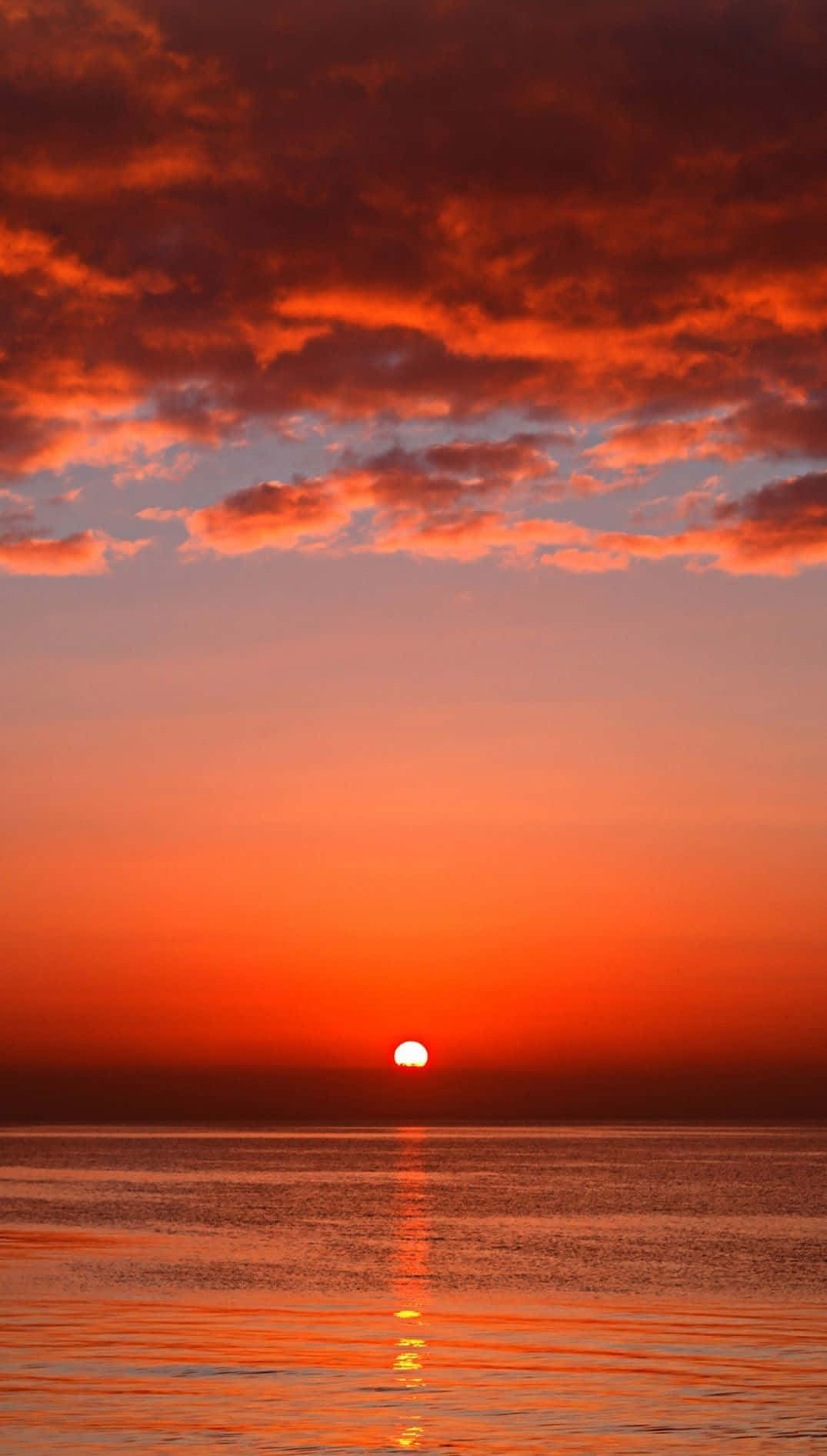 Breathtaking Orange Sunset over the Horizon Wallpaper