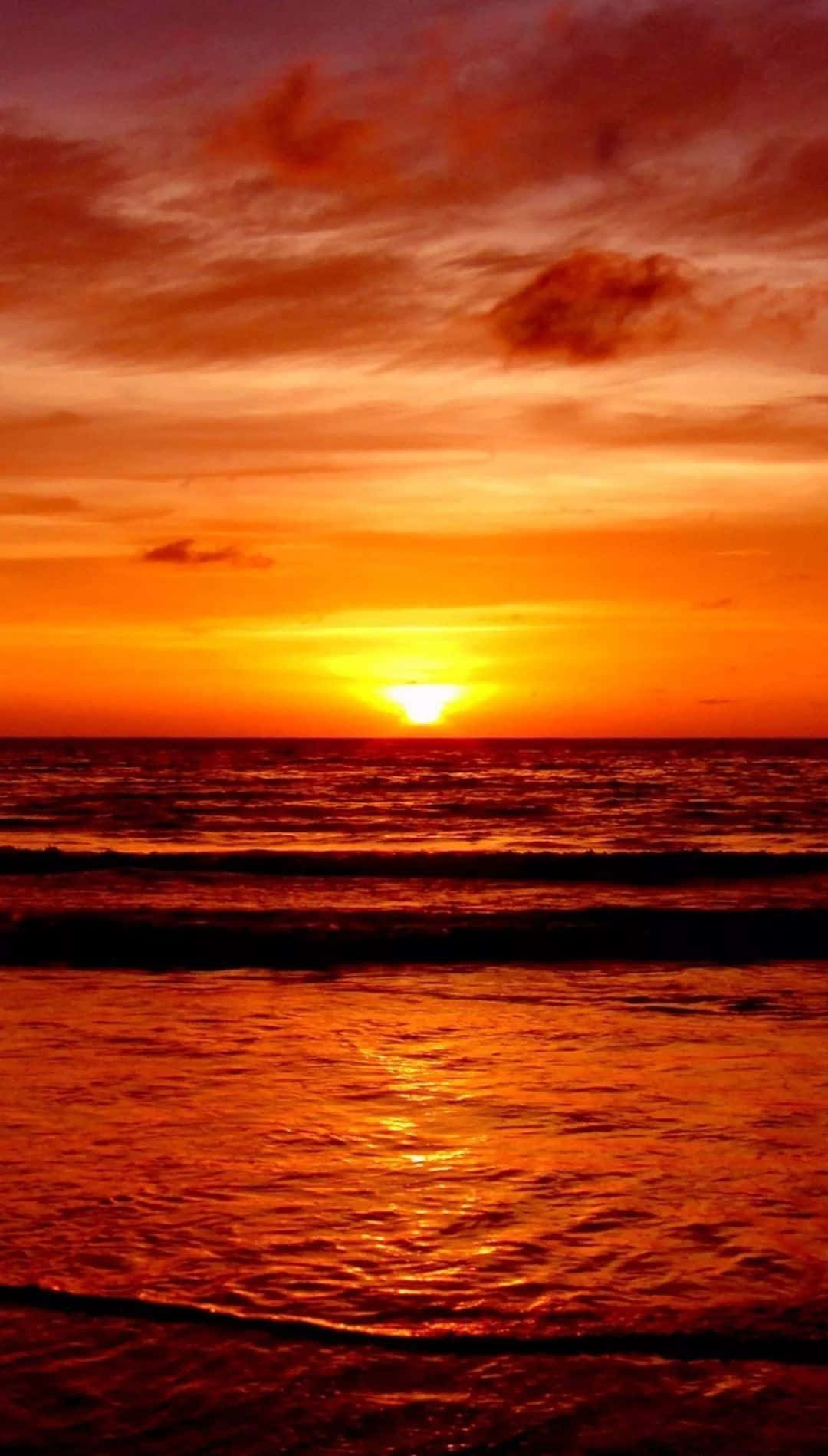 Captivating Orange Sunset Over the Ocean Wallpaper