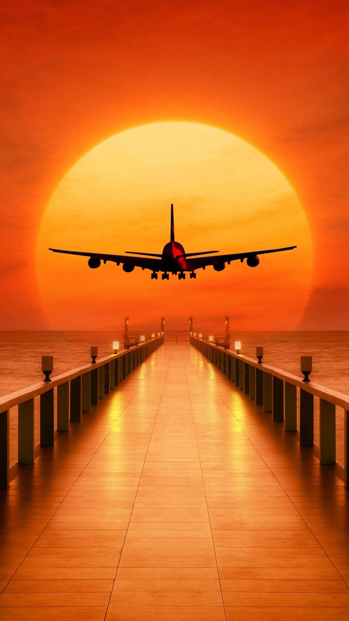 Orangesonnenuntergang Mit Flugzeug Für Android Wallpaper