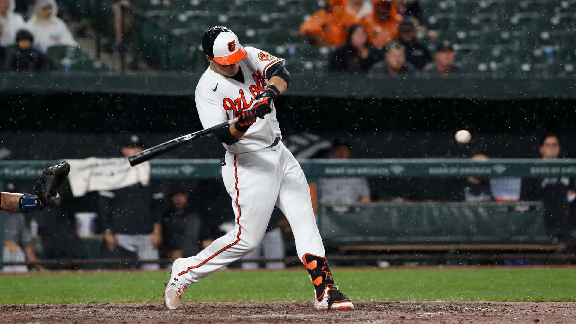 Orioles Player Hitting Baseballin Rain Wallpaper