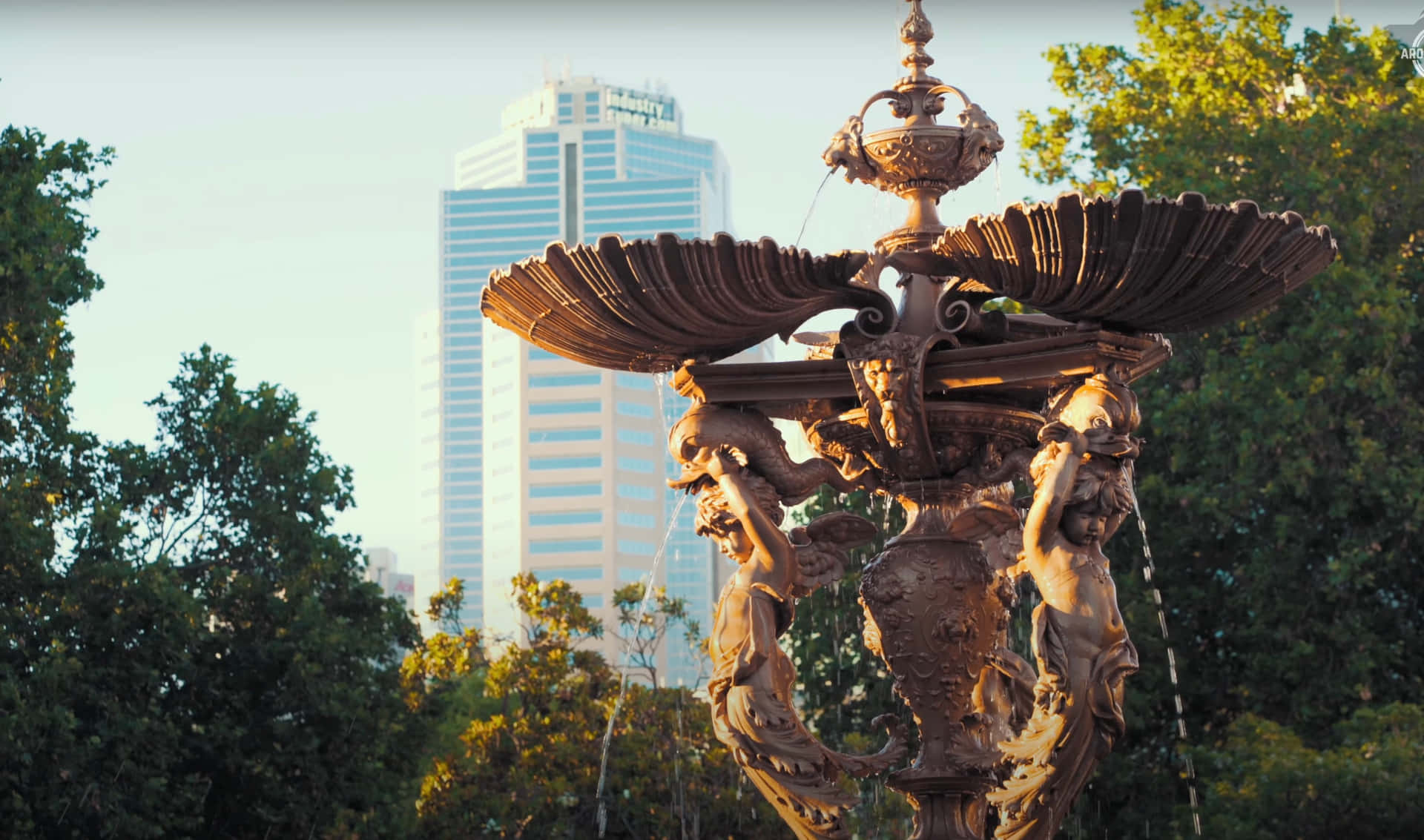 Ornate_ Fountain_with_ Modern_ Skyscraper_ Backdrop.jpg Wallpaper