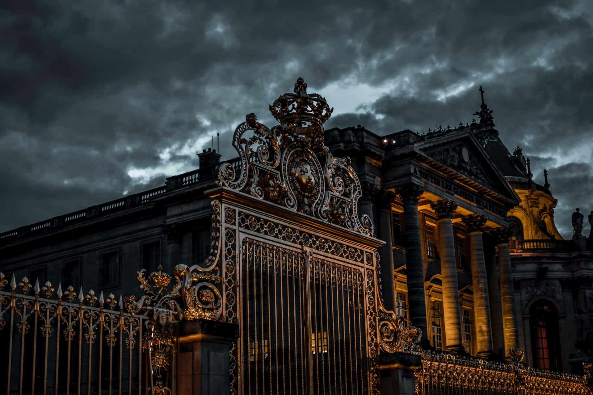 Ornate_ Palace_ Gate_ Under_ Cloudy_ Skies Wallpaper