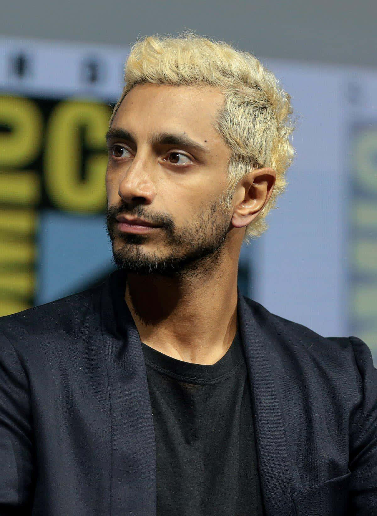 Oscar Nominee Riz Ahmed Captured In A Pensive Mood Wallpaper