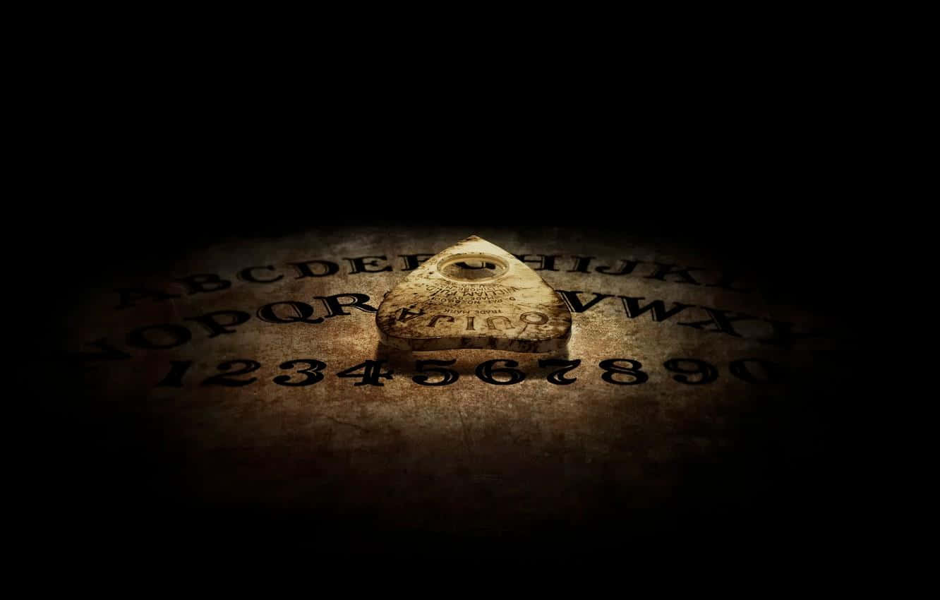 Reach out to the spirits with an Ouija Board Wallpaper