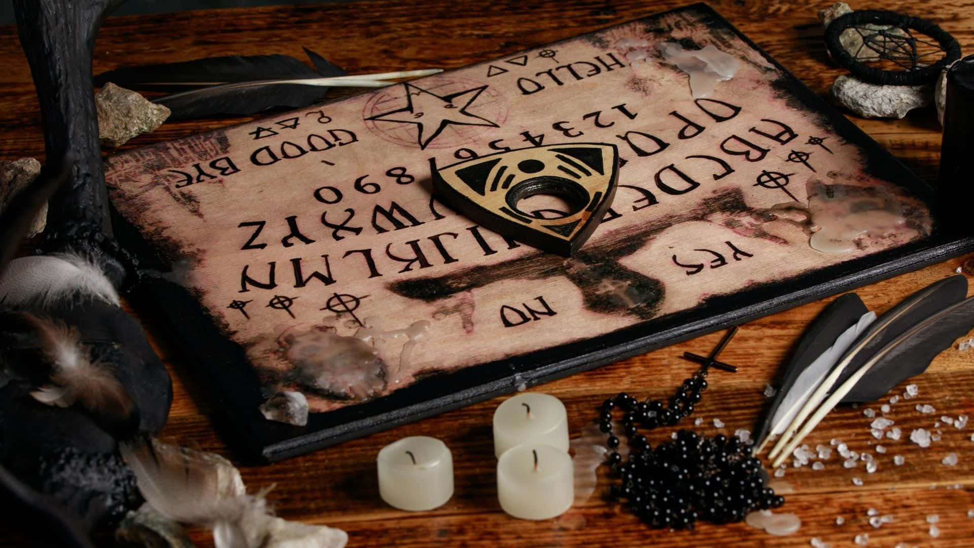 "Unlock the mysteries of the spirit world with a Ouija Board." Wallpaper