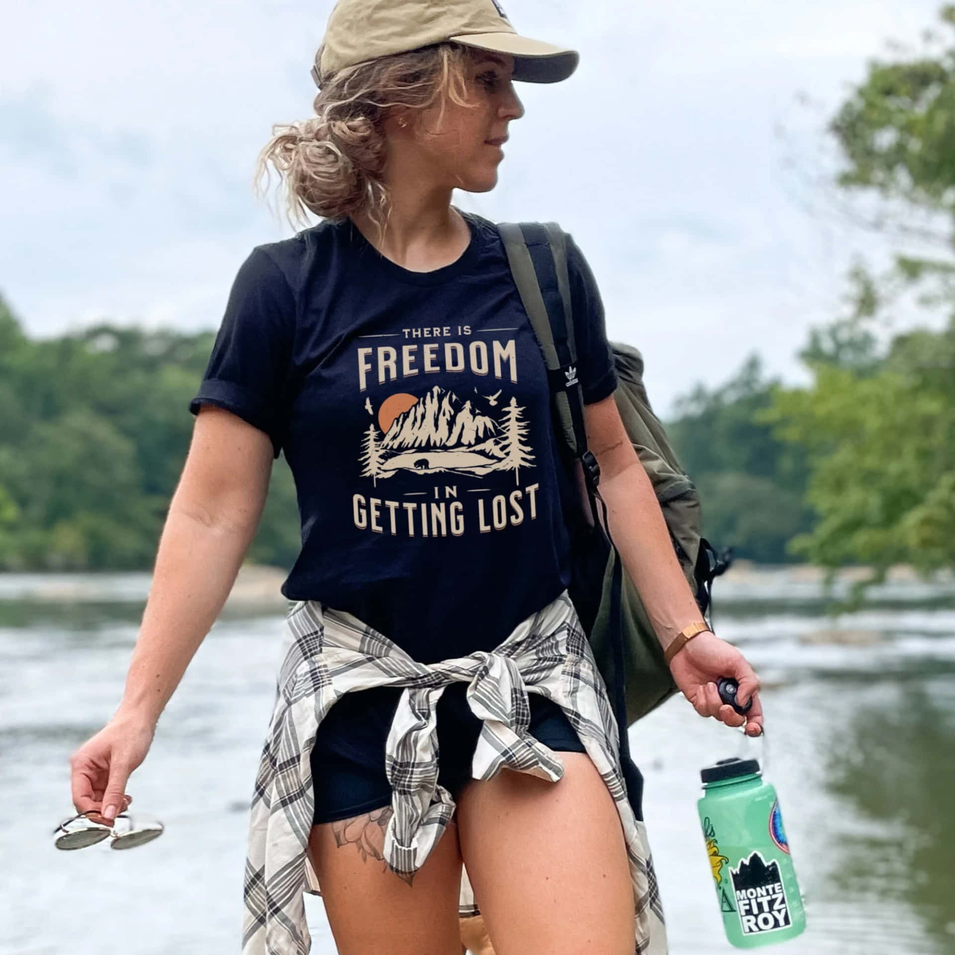 Outdoor Adventure Enthusiast Woman Riverbank Wallpaper