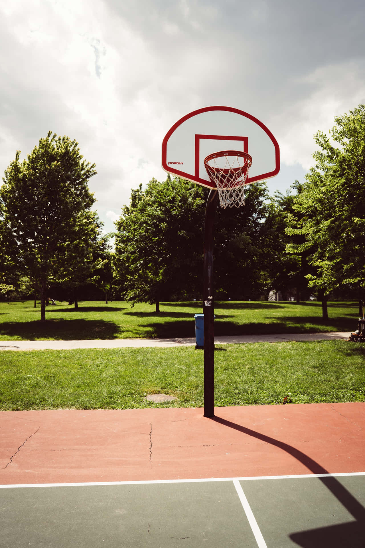 Half basketball courts with view of majestic mountain and overcast gray sky  Stock Photo