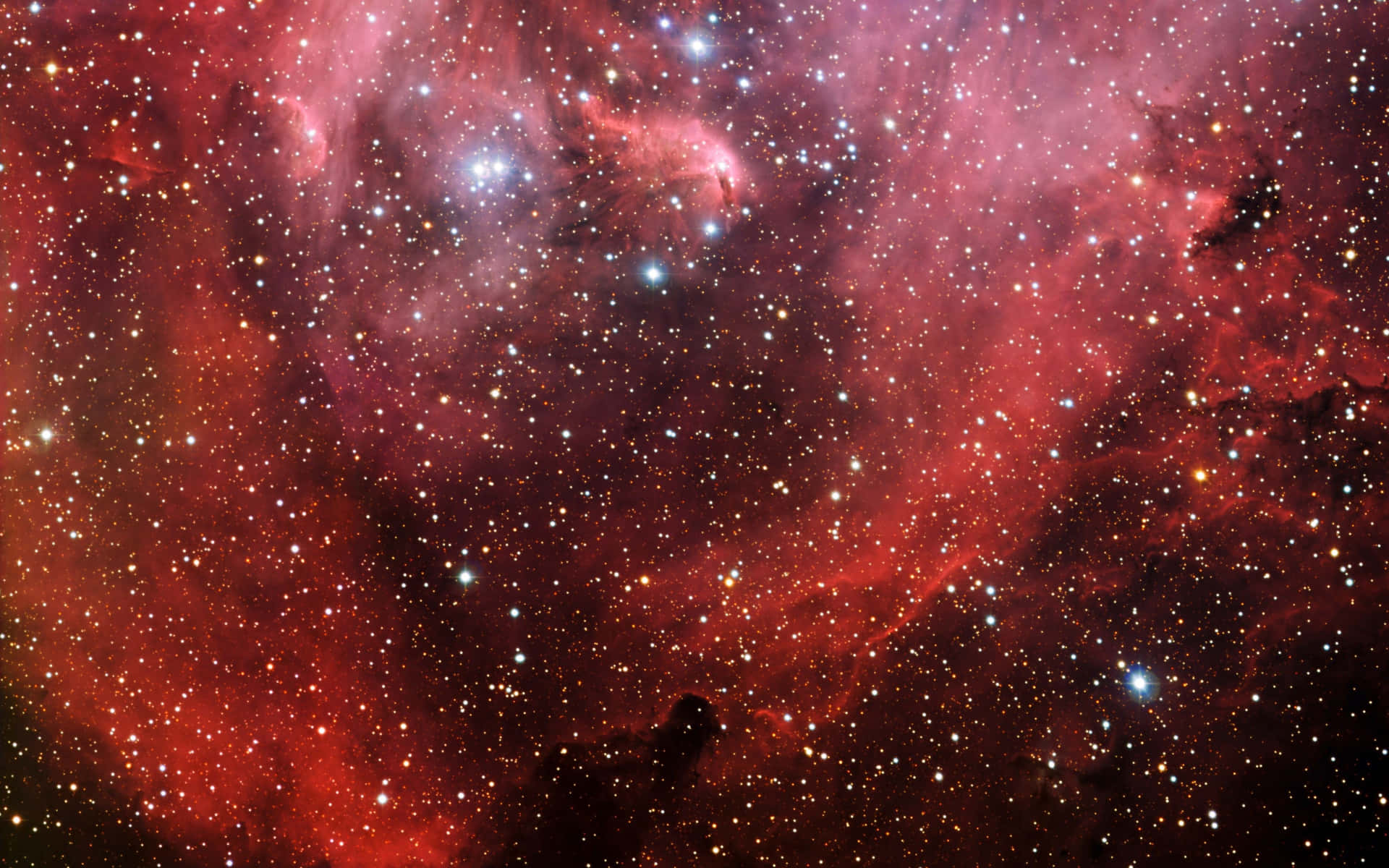 Witness the breathtaking beauty of an outer space fog illuminated by a deep red hue Wallpaper