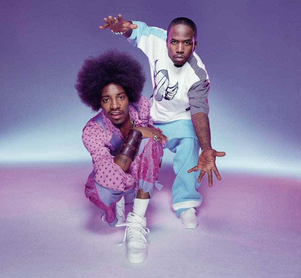 Download Outkast Duo Pose Purple Backdrop Wallpaper | Wallpapers.com