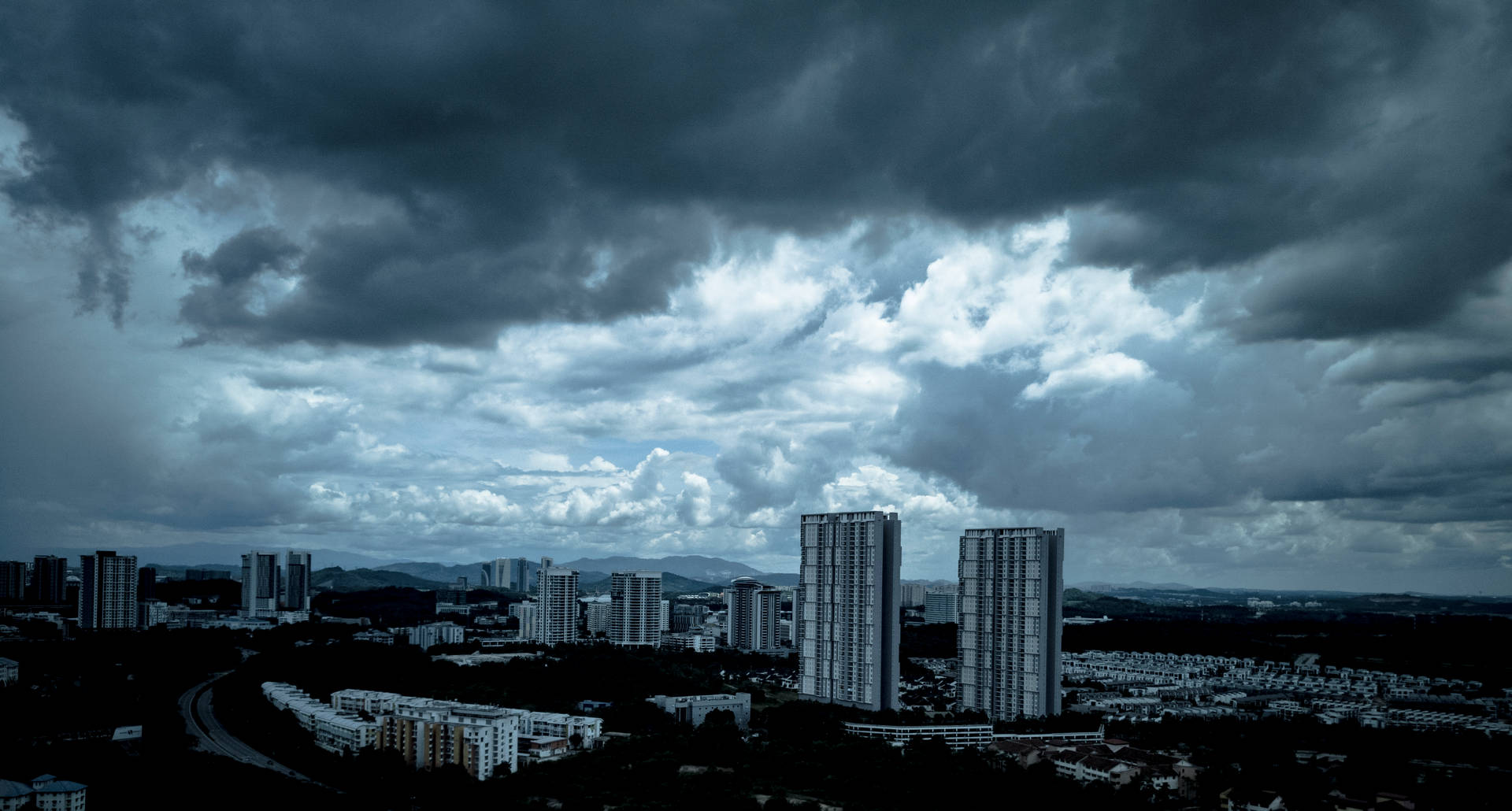 Overcast Dark Blue Clouds Over City Wallpaper