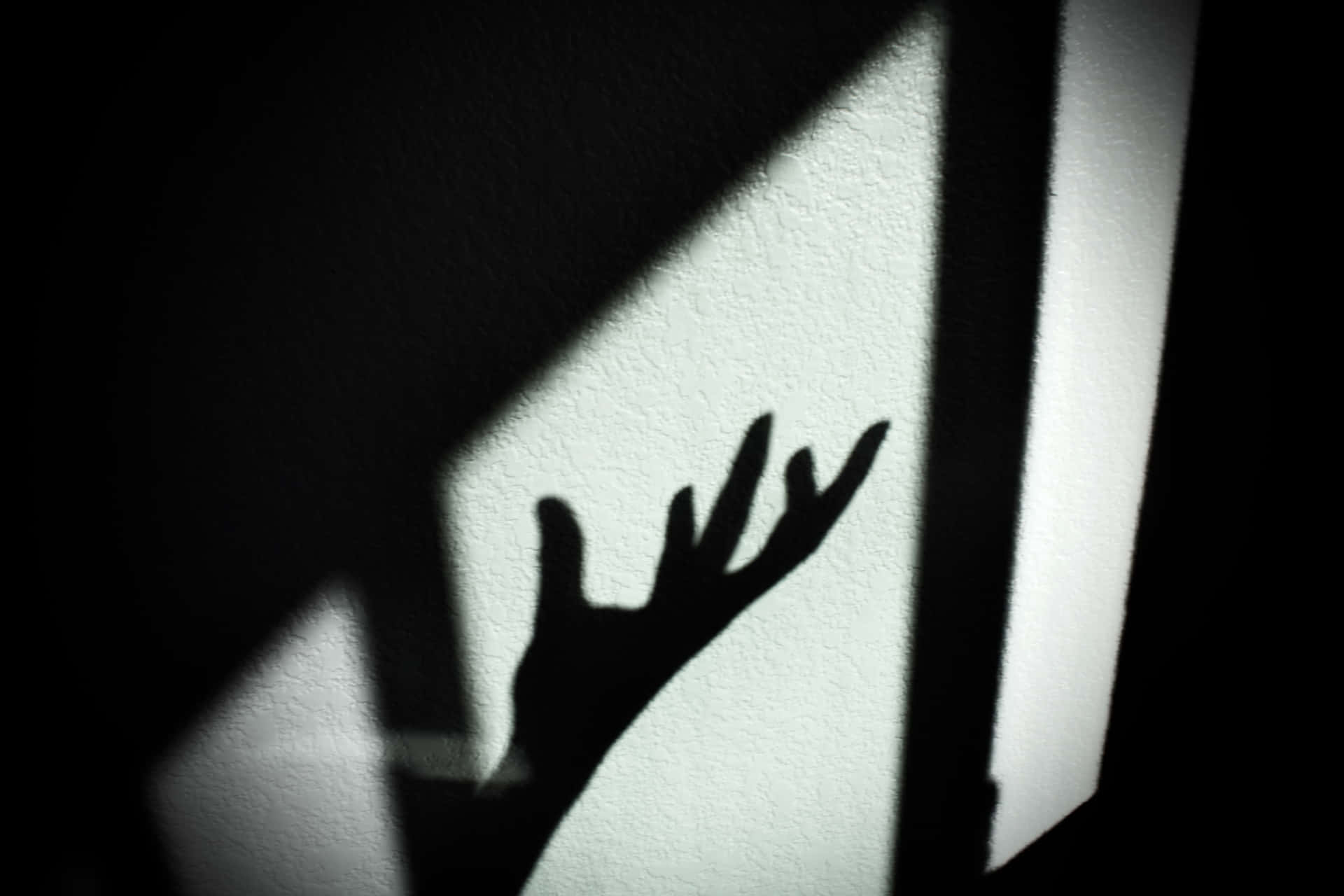 Overwhelmed Person's Hand Shadow Wallpaper