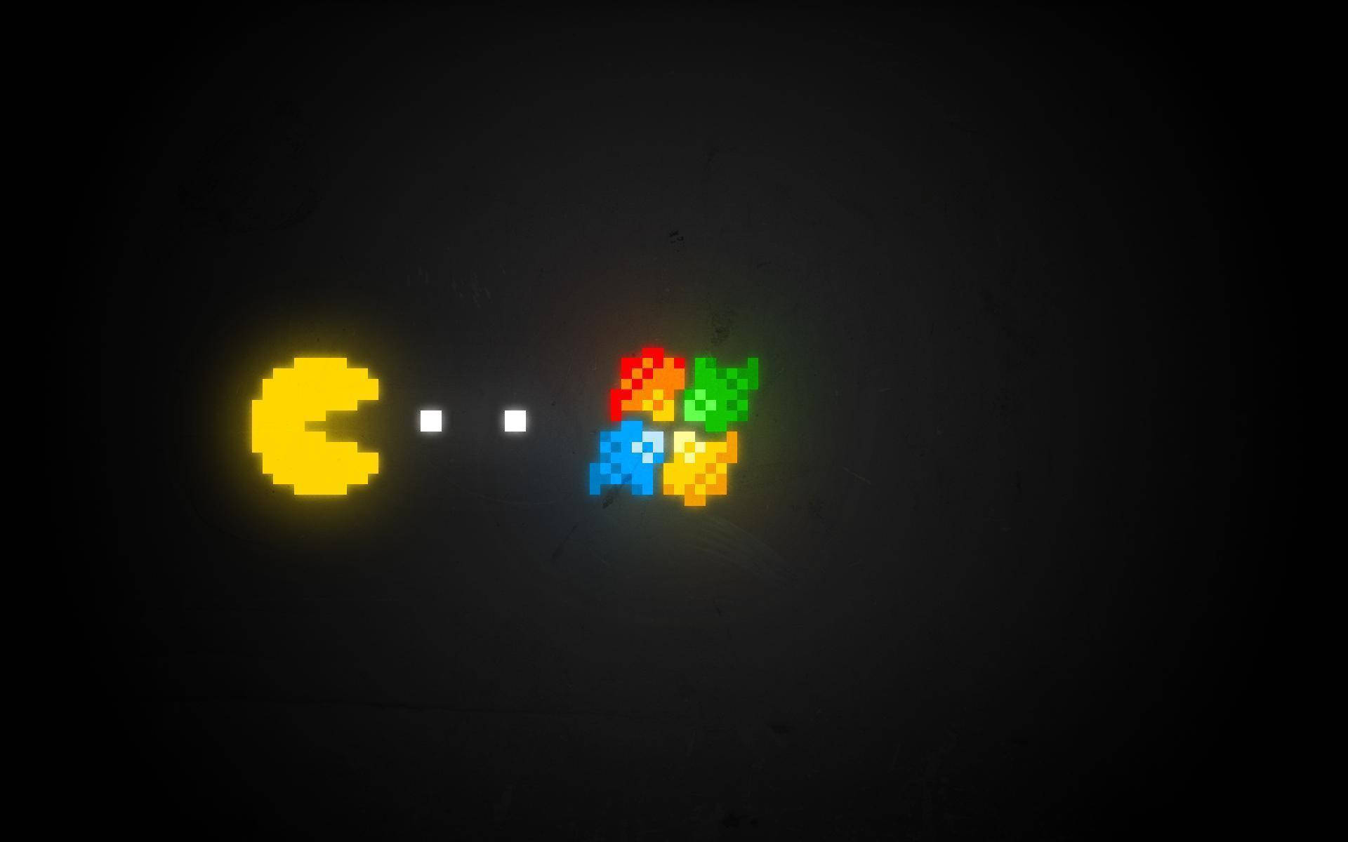 Pacman Äter Windows-logotypen På Bakgrunden. Wallpaper
