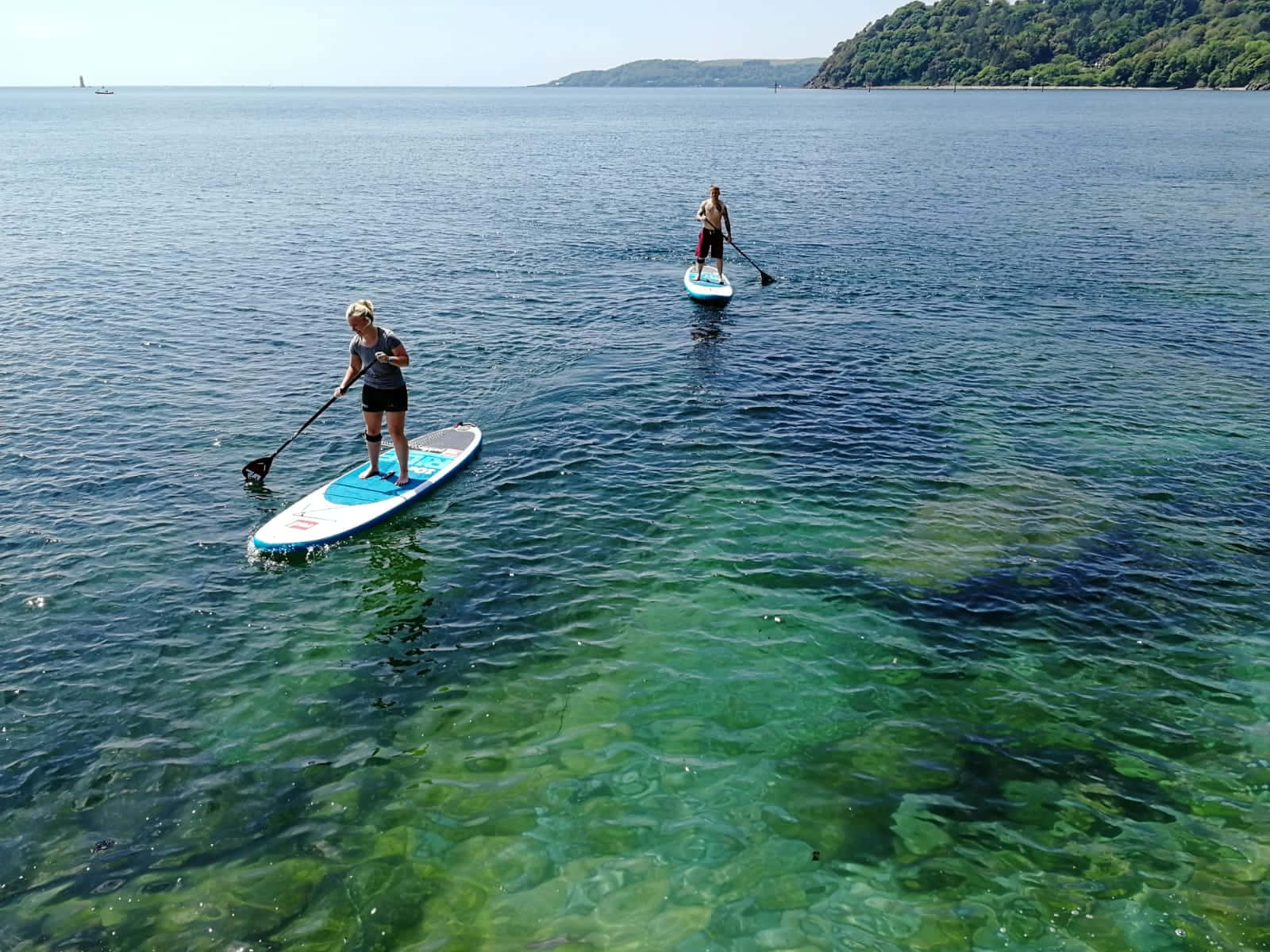 Paddleboarding Adventure on a Serene Lake Wallpaper