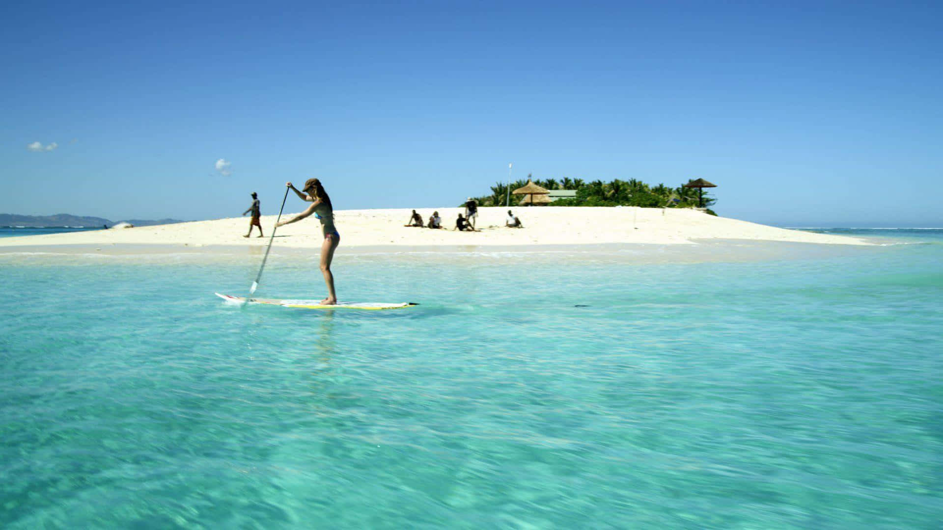 Paddleboarding on a beautiful sunny day Wallpaper