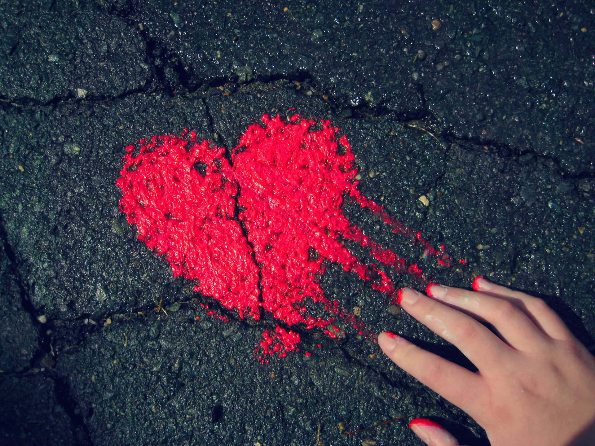 En persons hånd berører et rødt hjerte på livets vej Wallpaper