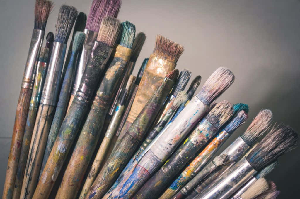 A Group Of Paint Brushes Are Arranged In A Pile