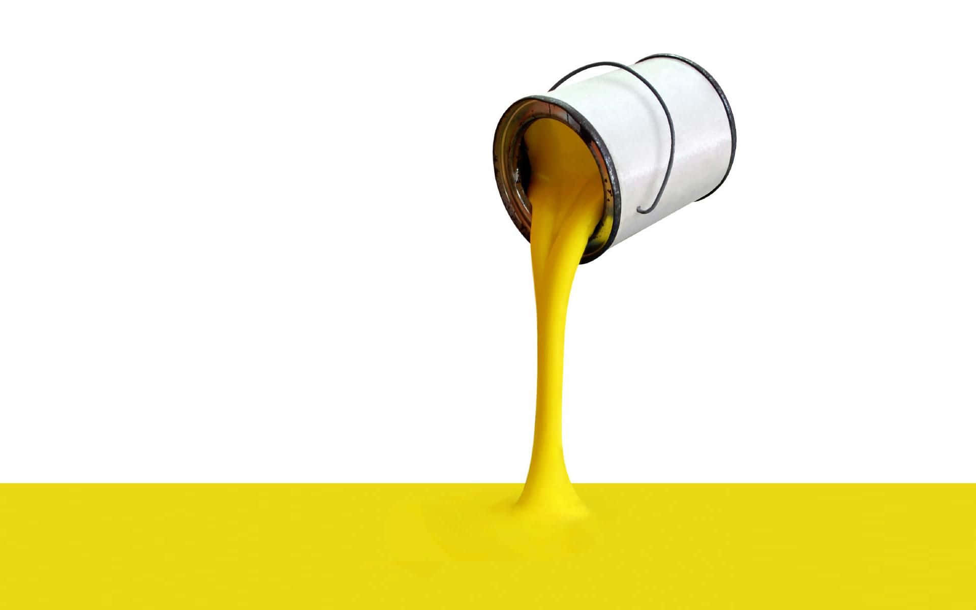 A Yellow Paint Is Pouring Out Of A Can