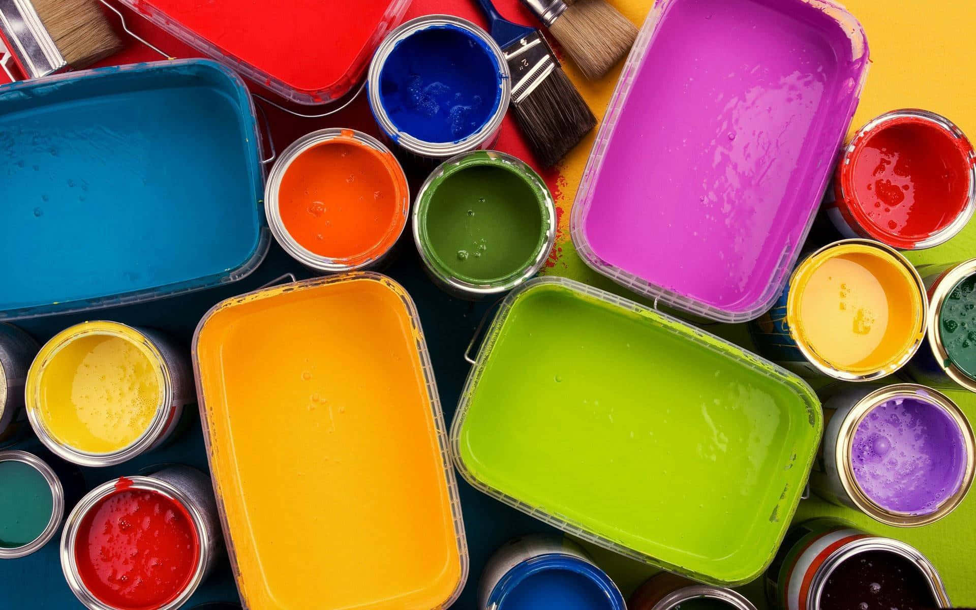 A Colorful Paint Can With Paint Brushes And Paint