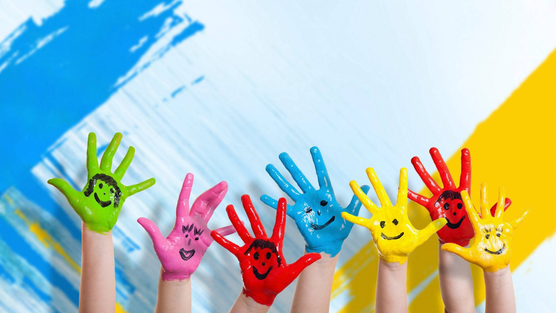 Painted Children's Hands With Happy Faces Wallpaper