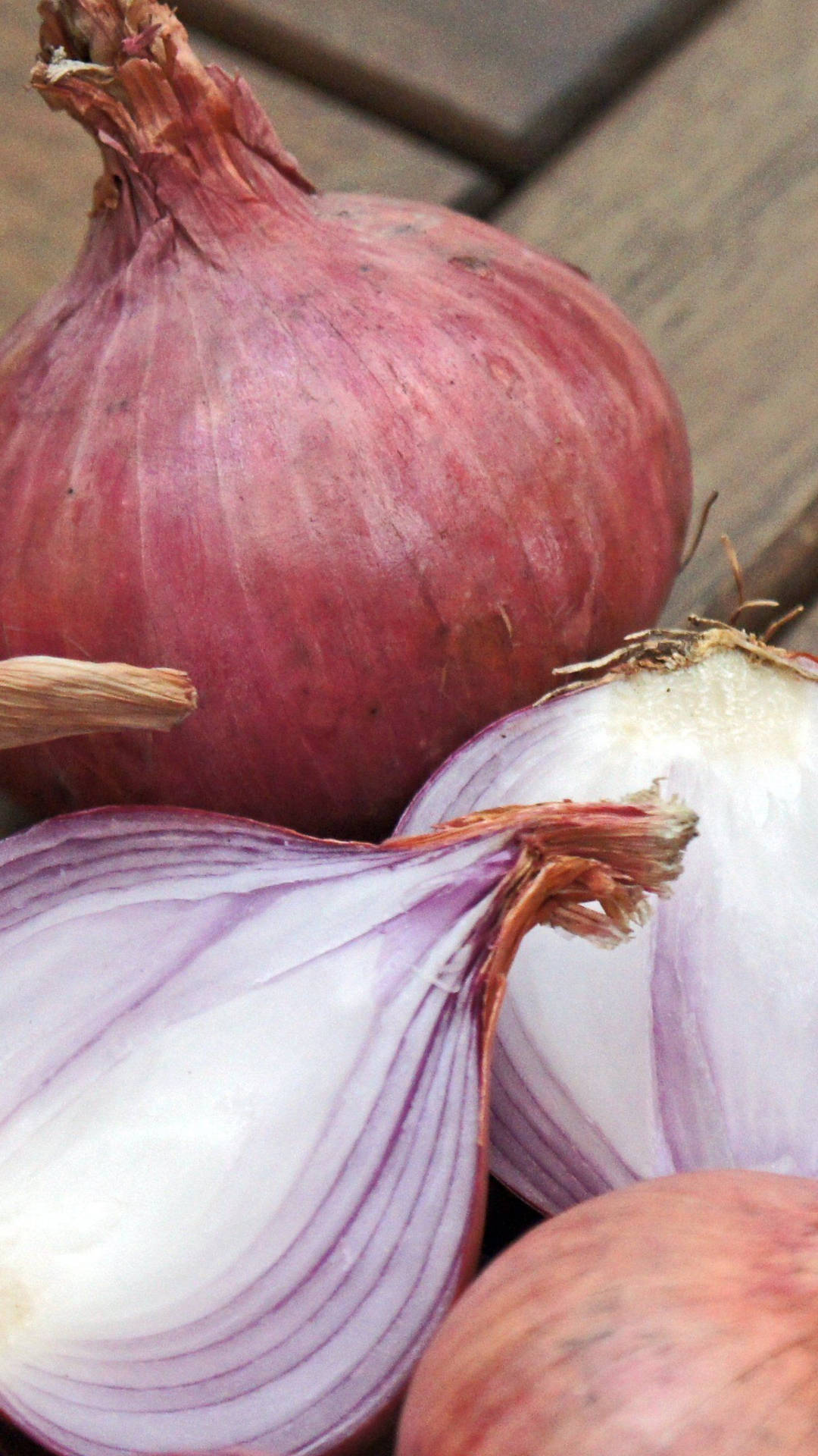Pale Red Onions On Wooden Planks Wallpaper