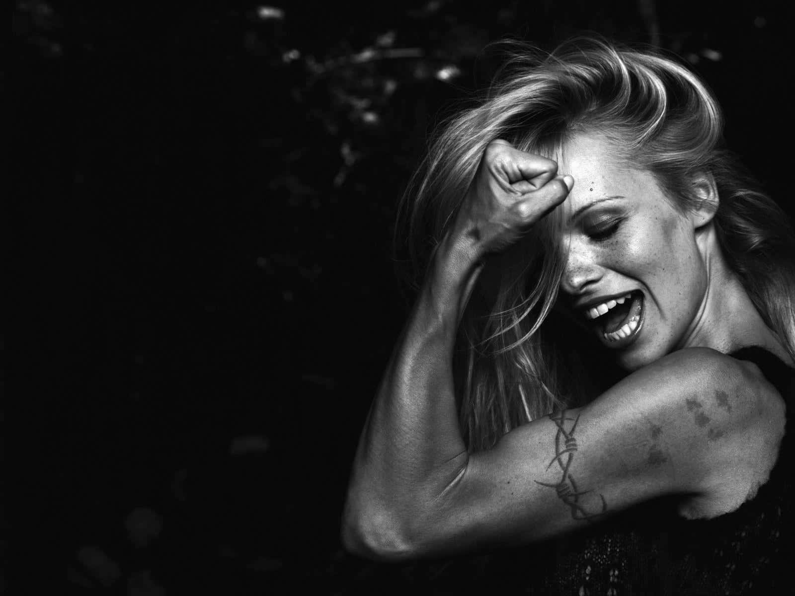 Pamela Anderson posing in a stunning photoshoot Wallpaper