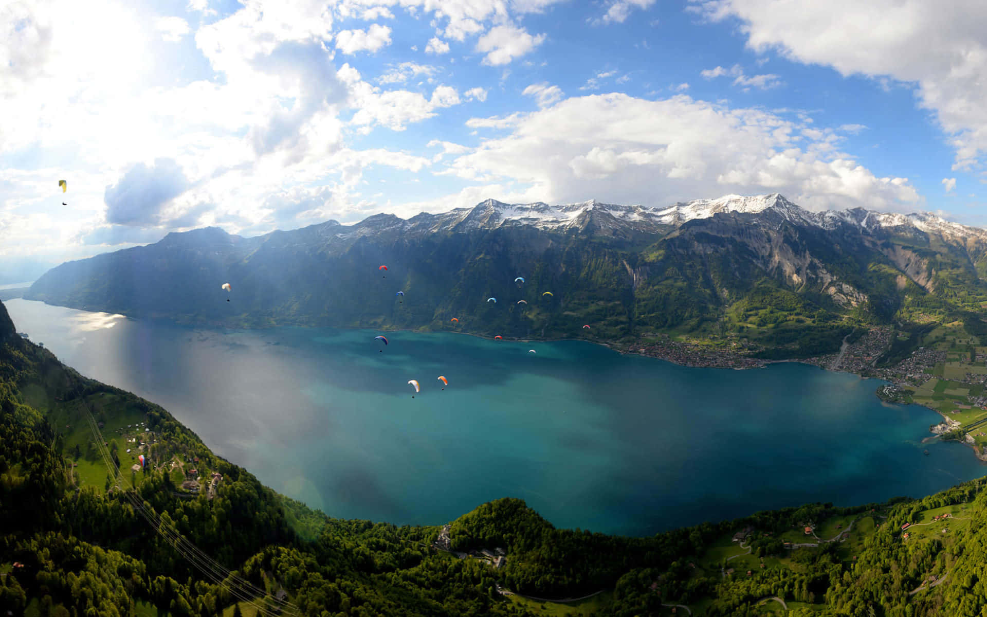 Panoramic Viewof Lake Thunwith Paragliders Wallpaper