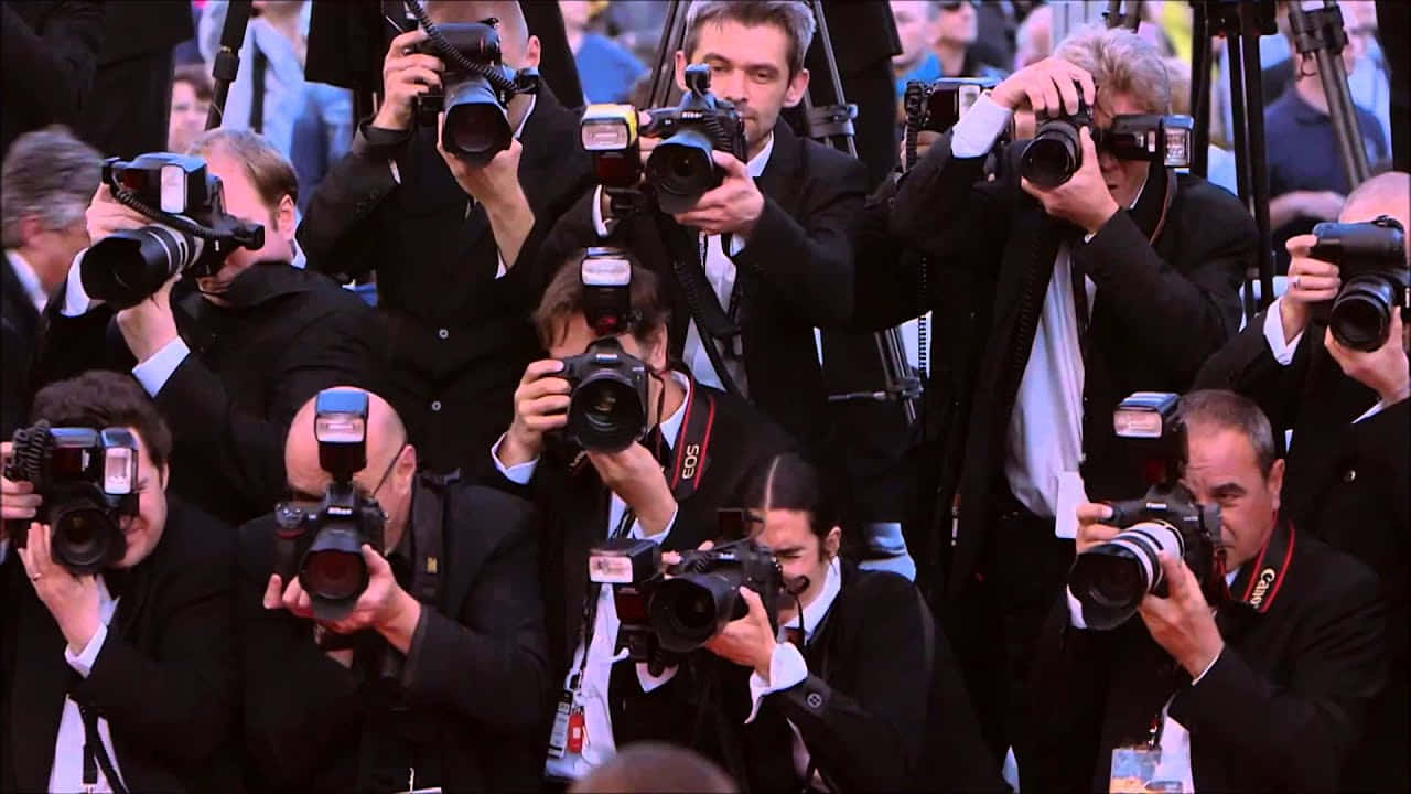 Paparazzi with cameras waiting for a celebrity