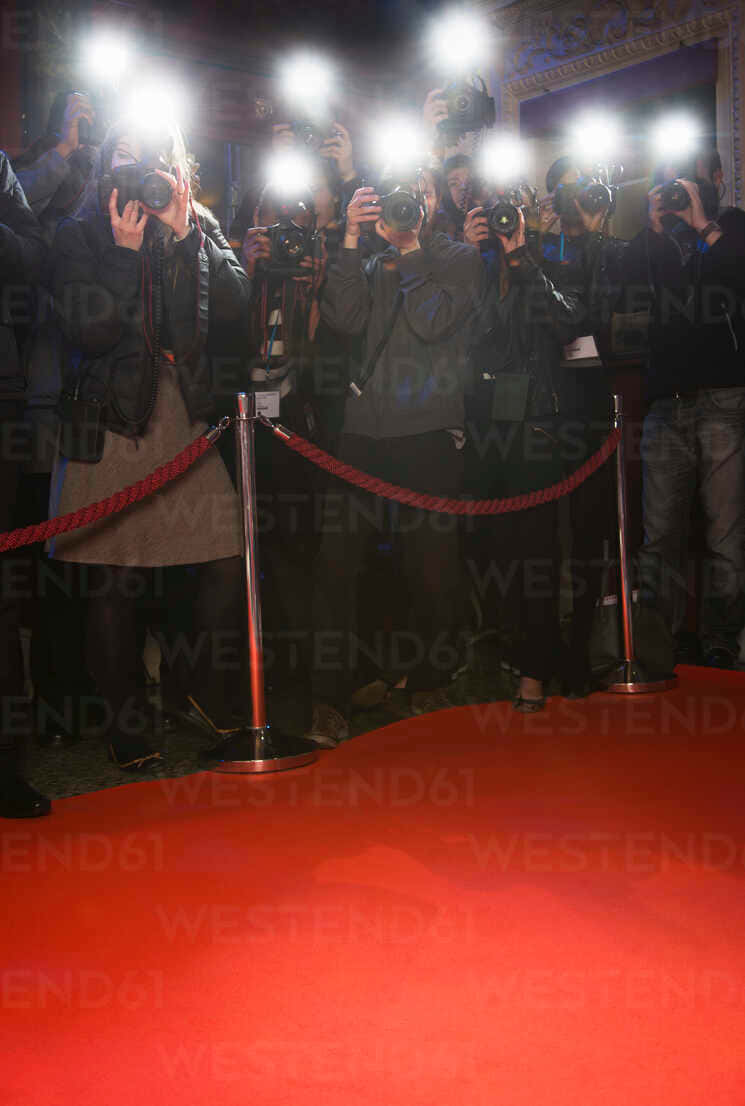 Paparazzi photographers capturing a famous star on the red carpet Wallpaper