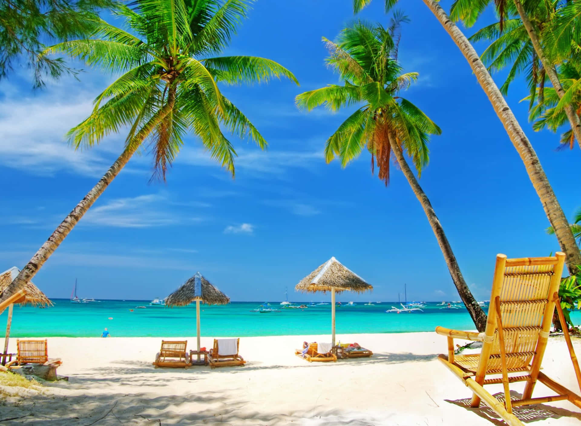A Beach With Chairs And Palm Trees