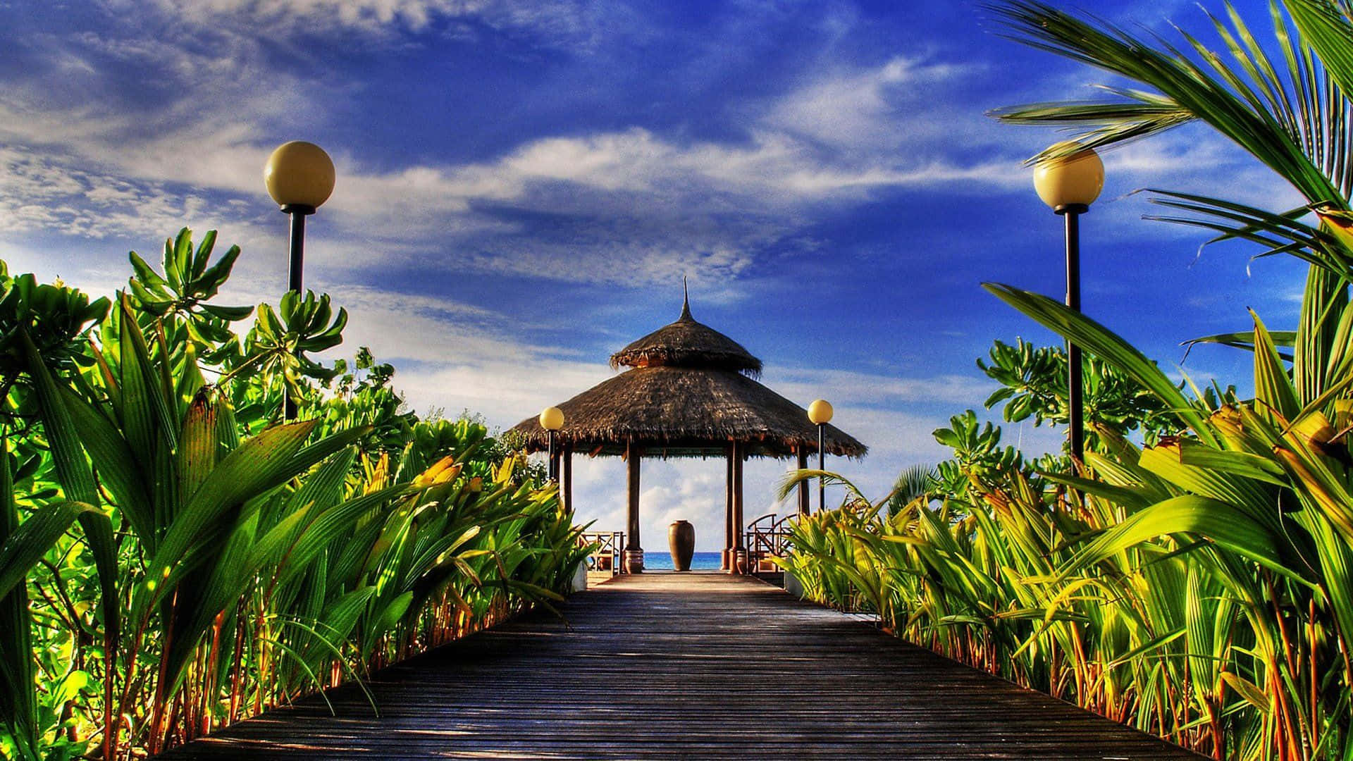 A Wooden Walkway Leading To A Gazebo