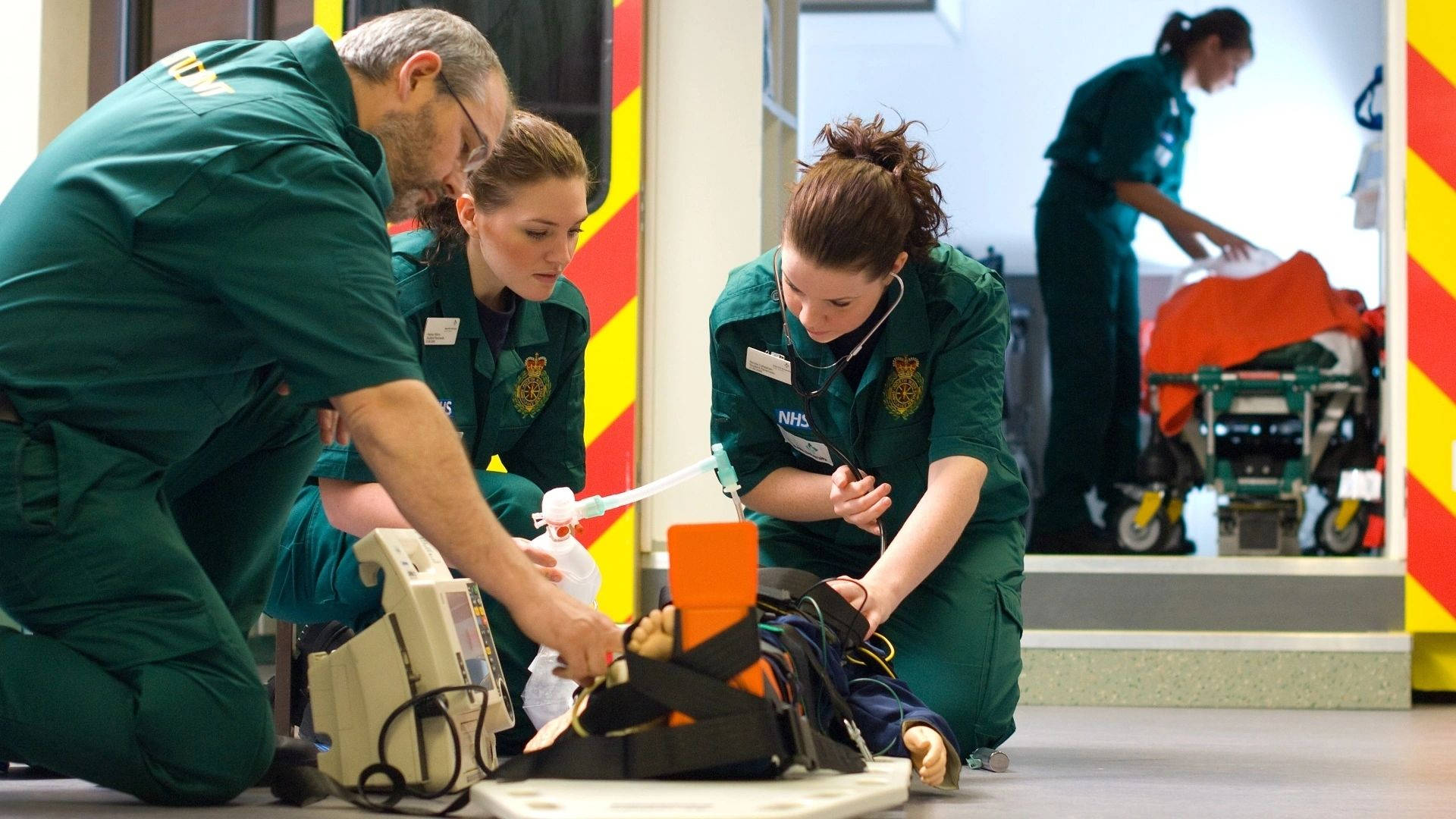 Professional Paramedic Team Providing First Aid Wallpaper