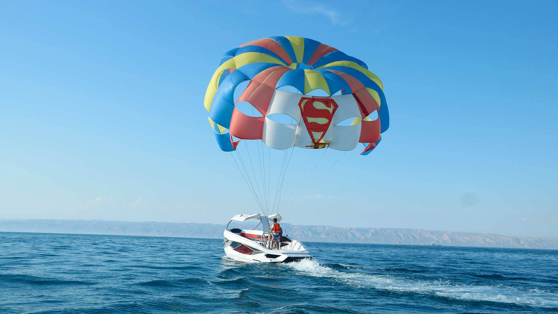 Parasailing Adventure in Prism Blue Waters Wallpaper