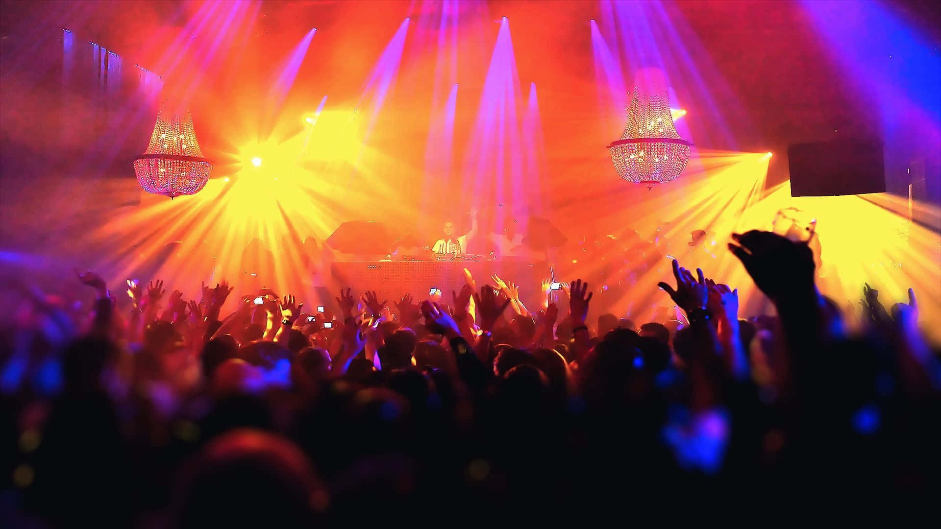 A Crowd At A Concert With Bright Lights