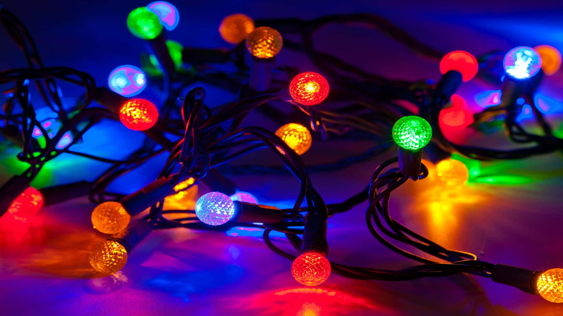 Multi Colored Christmas Lights On A Dark Background