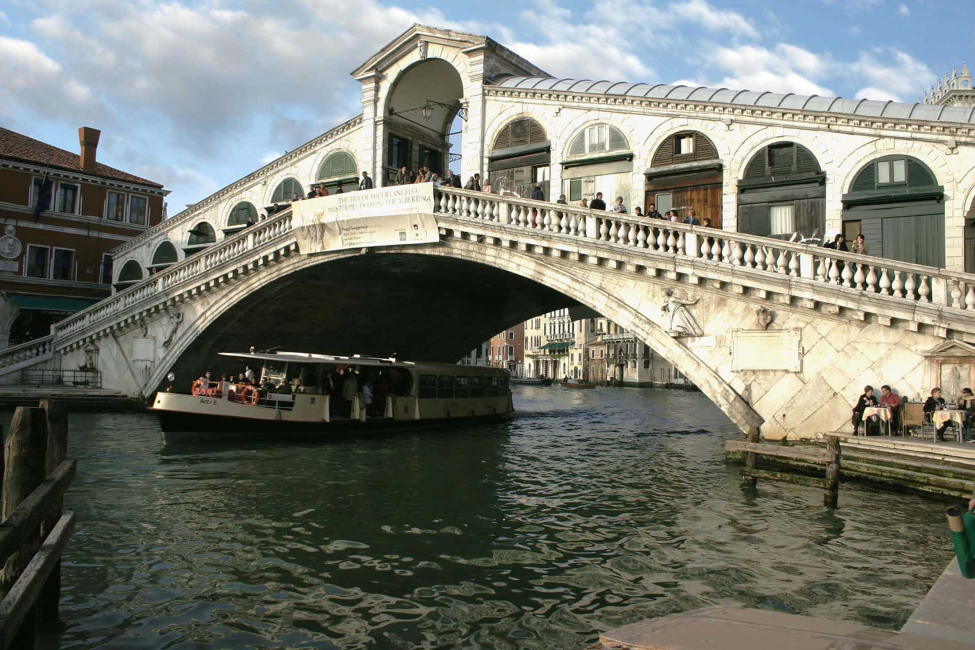 Passing Ferry Under Rialto Bridge In Venice Italy Wallpaper