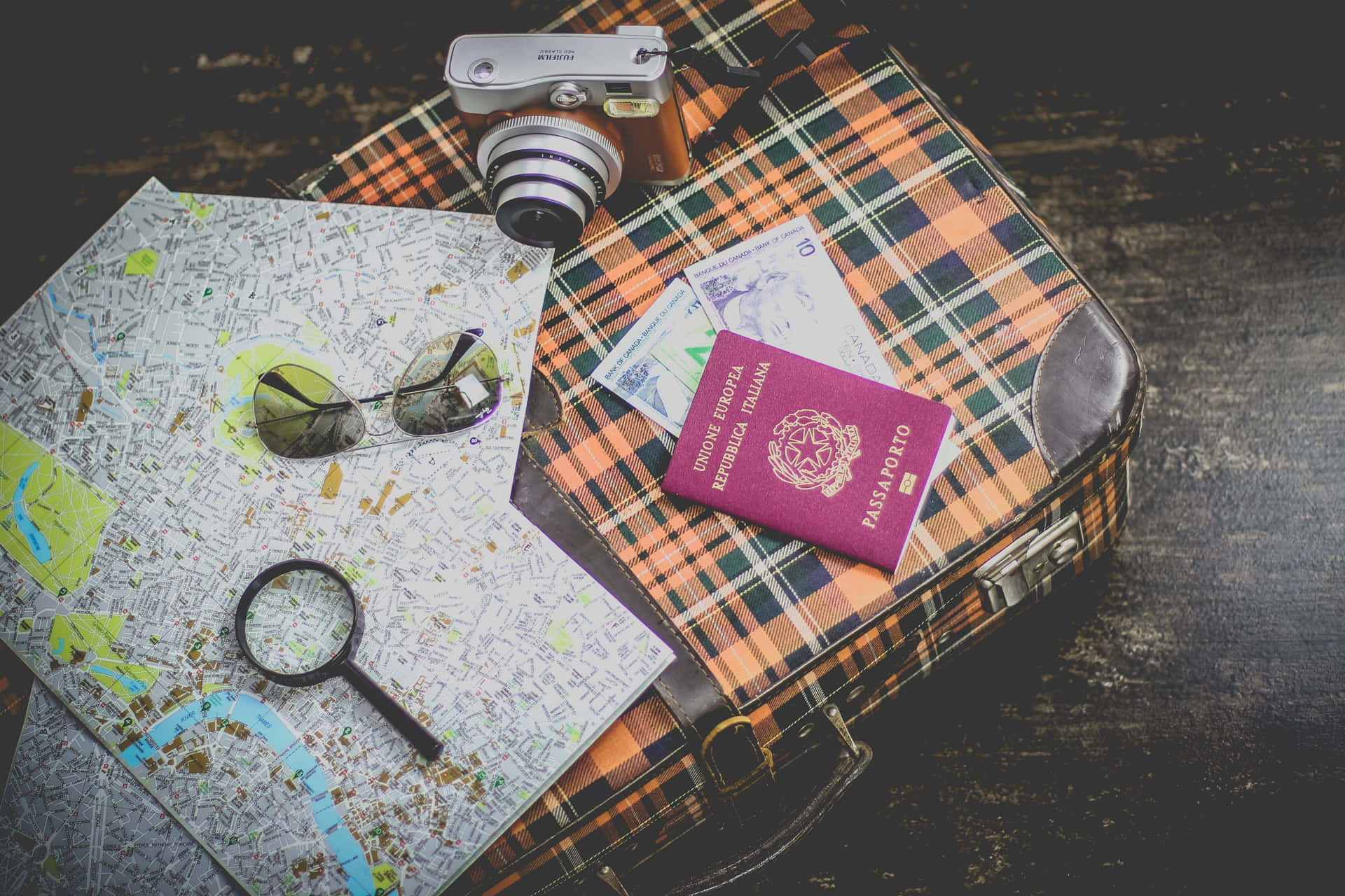 A Suitcase With Passport, Glasses, And A Magnifying Glass