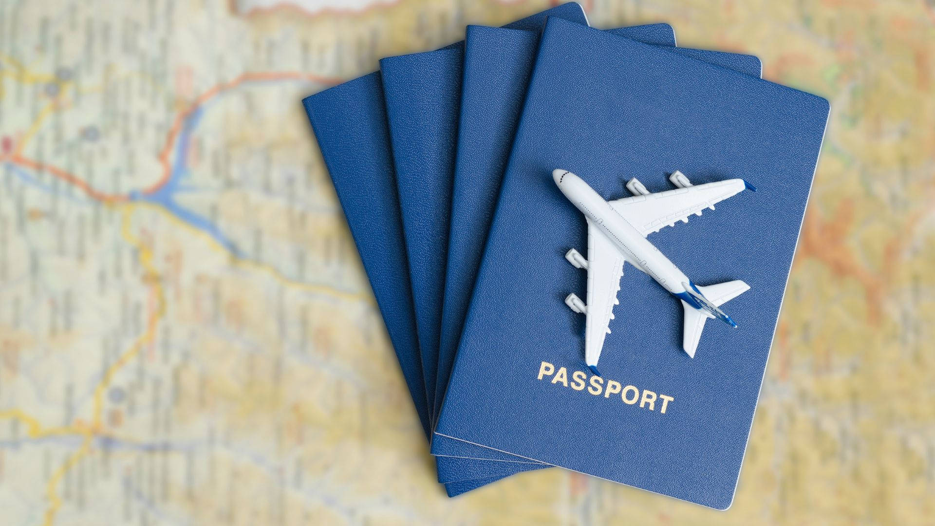 Passport With Toy Airplane On Top Wallpaper