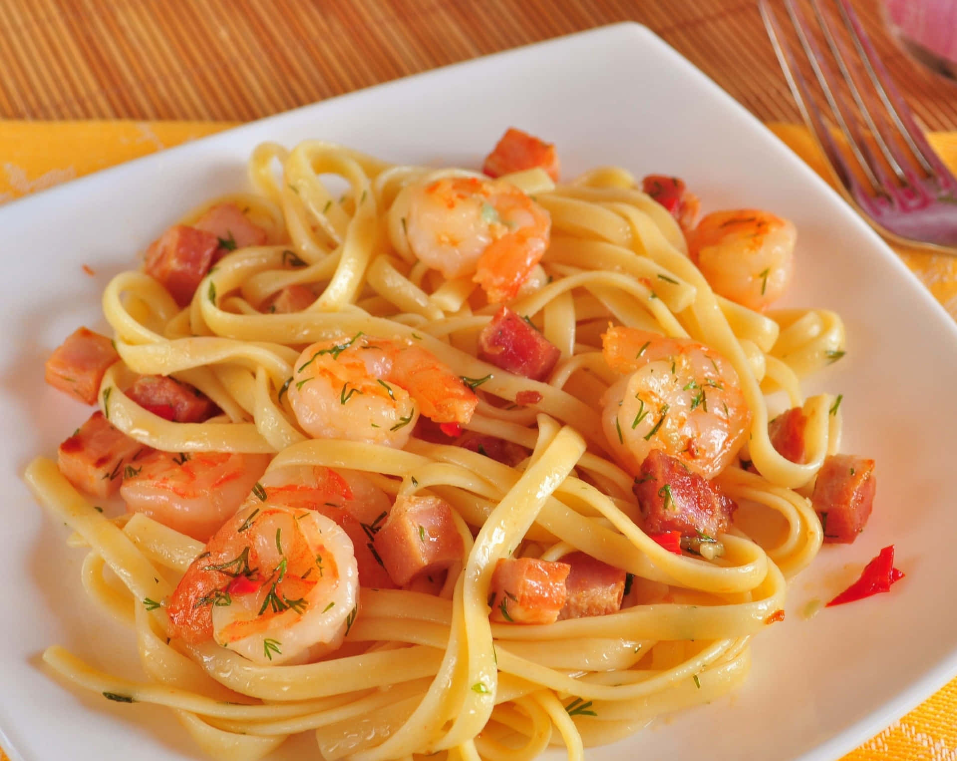 A Plate Of Pasta With Shrimp And Bacon