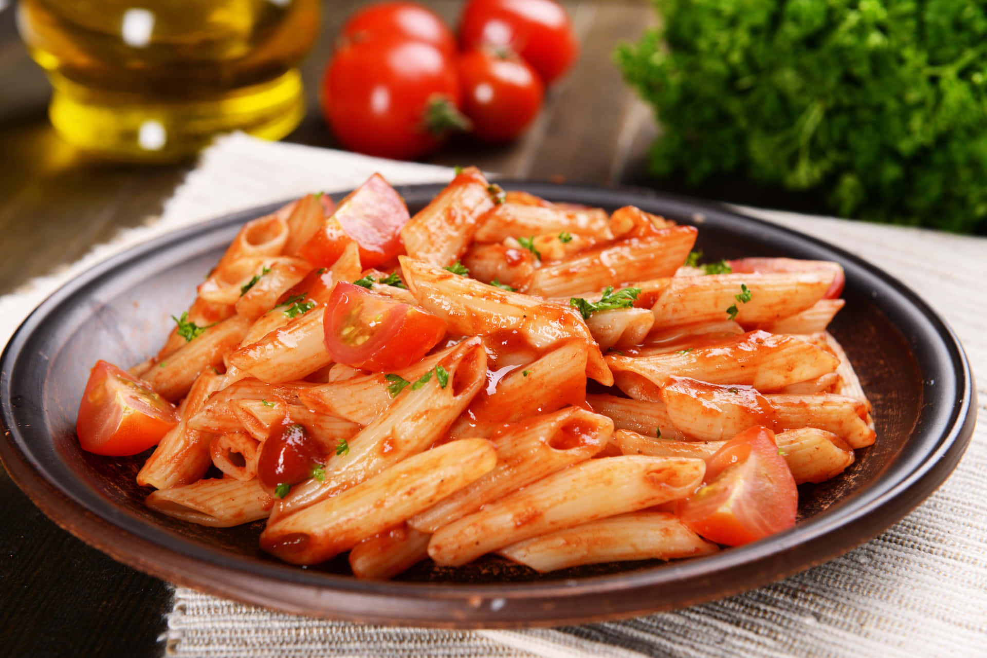 A Plate Of Pasta With Tomatoes And Basil