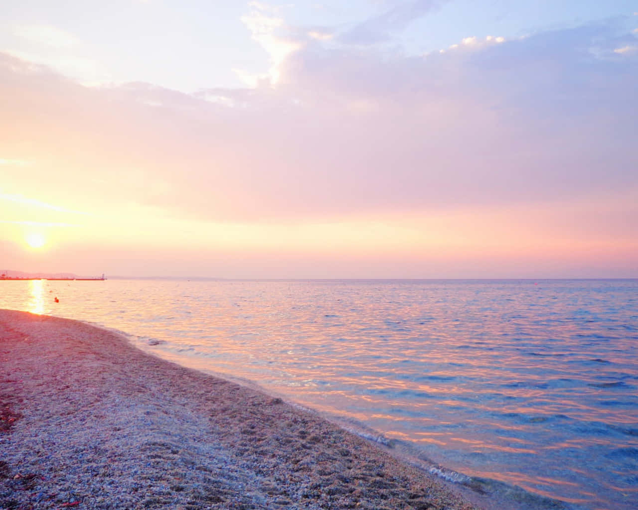Enjoy a tranquil moment in pastel colors at the beach Wallpaper