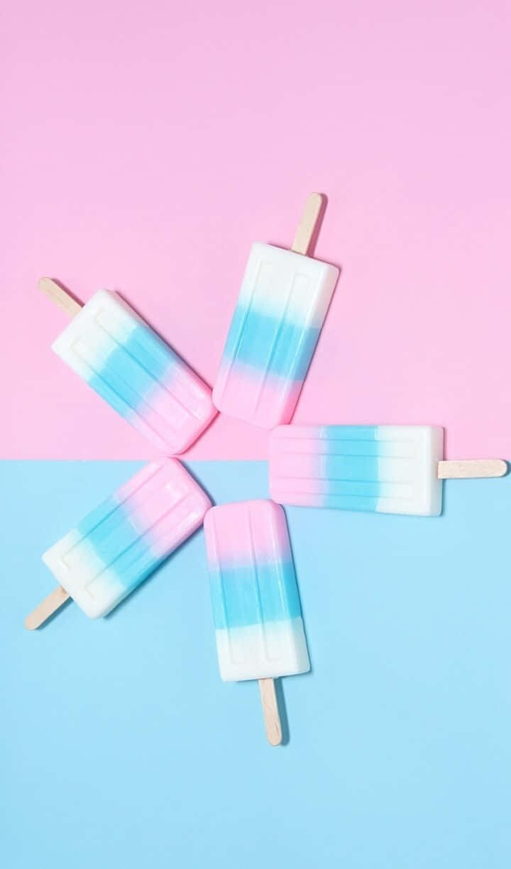 A Group Of Popsicles On A Pink And Blue Background Wallpaper
