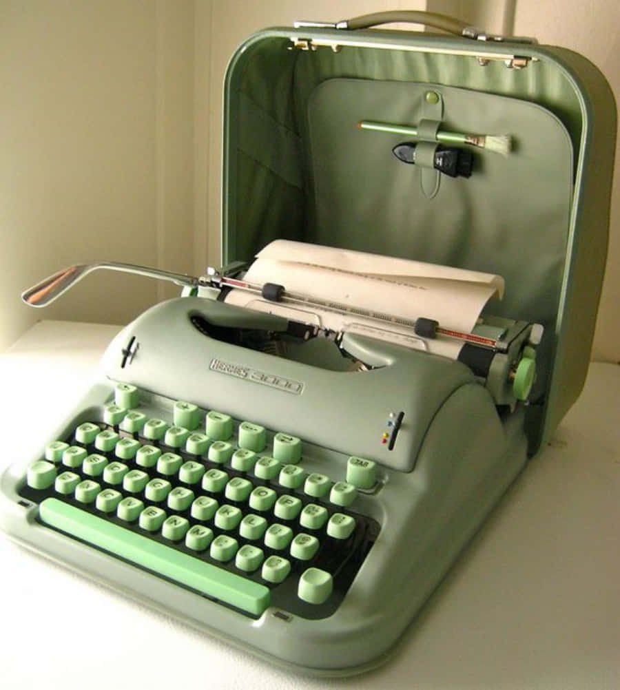 A Green Typewriter With A Paper In It Wallpaper