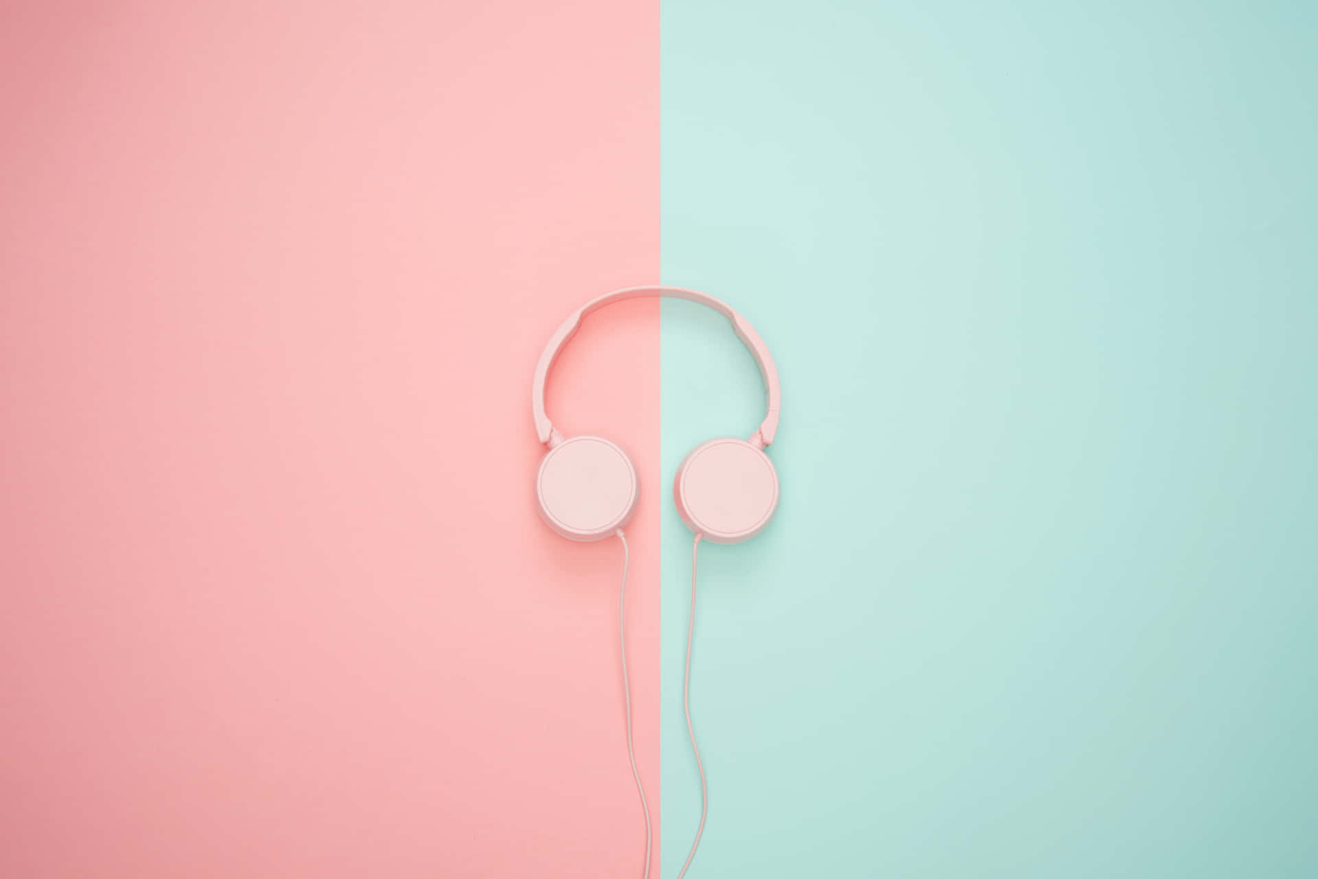 Pink Headphones On A Pink And Blue Background Wallpaper