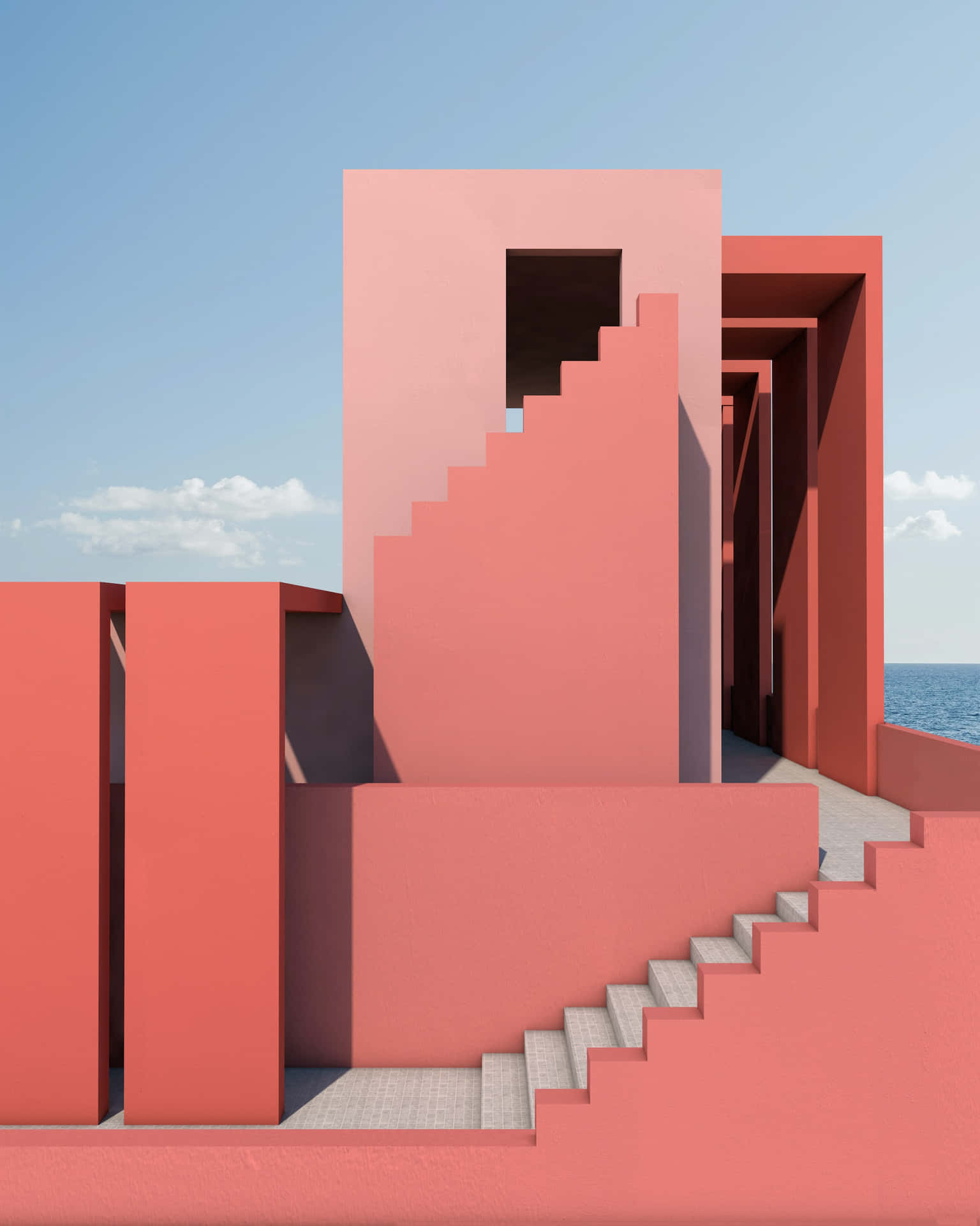 A Pink Building With Stairs Leading To The Ocean