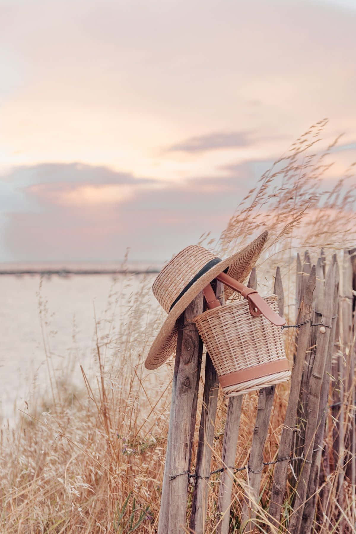 Pastel Summer Sunsetwith Straw Hatand Bag Wallpaper
