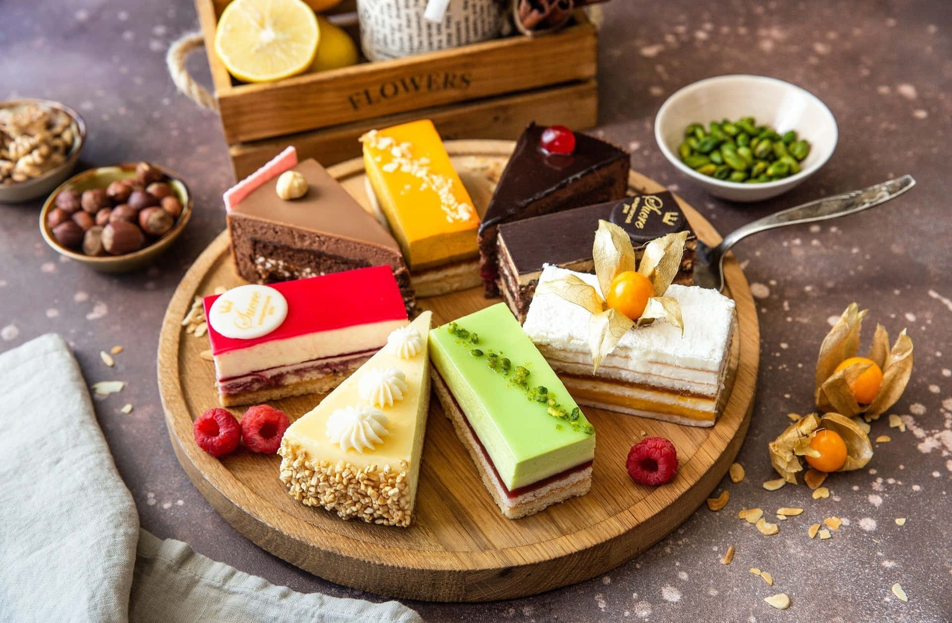 A Plate Of Different Types Of Cakes On A Wooden Table