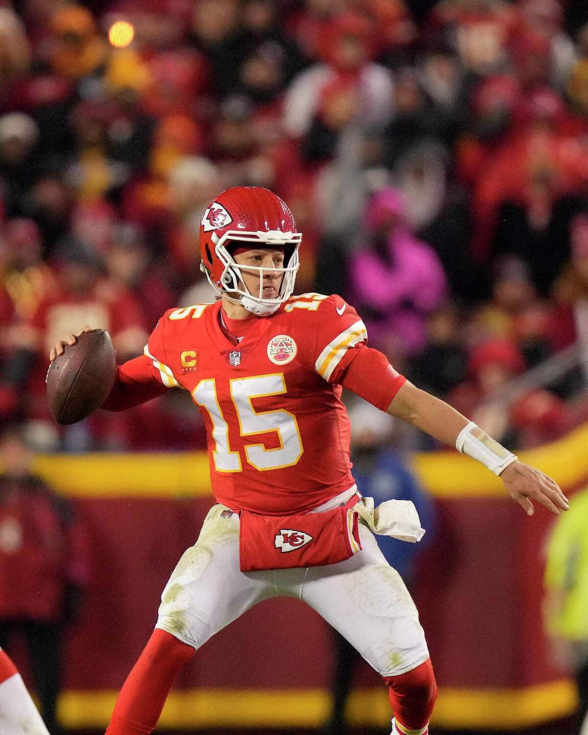 NFL superstar quarterback Pat Mahomes with his beloved phone Wallpaper